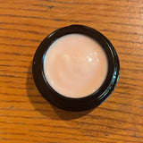 Pink Pearl Moisturizer in light filtering container 